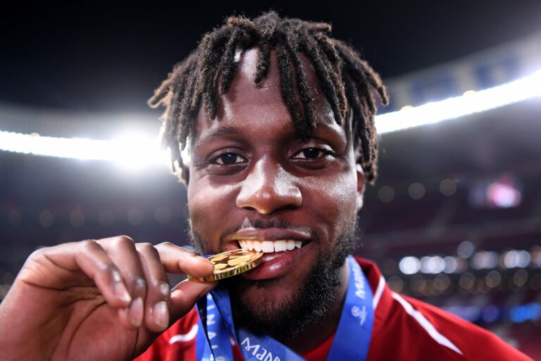 MADRID, SPAIN - JUNE 01: Divock Origi of Liverpool celebrates with his medal after winning the UEFA Champions League Final between Tottenham Hotspur and Liverpool at Estadio Wanda Metropolitano on June 01, 2019 in Madrid, Spain.