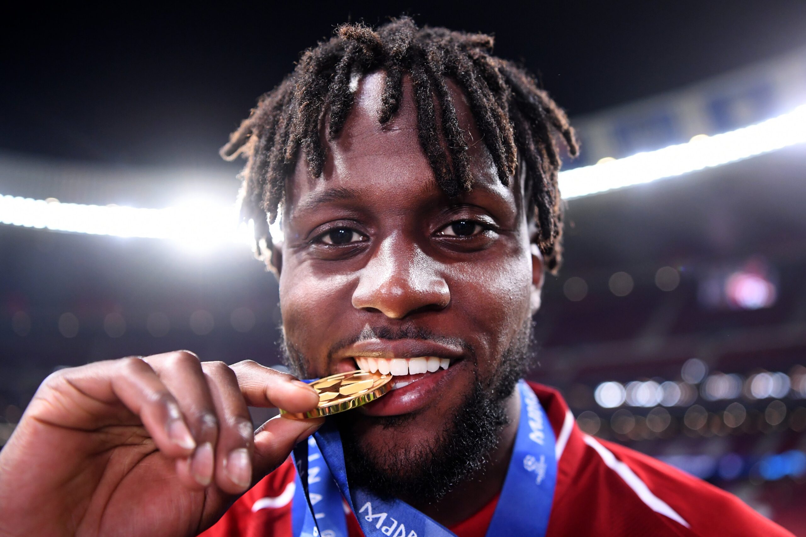 MADRID, SPAIN - JUNE 01: Divock Origi of Liverpool celebrates with his medal after winning the UEFA Champions League Final between Tottenham Hotspur and Liverpool at Estadio Wanda Metropolitano on June 01, 2019 in Madrid, Spain.
