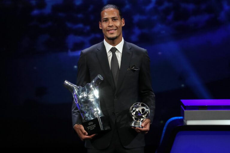 Liverpool's Dutch defender Virgil van Dijk poses with his trophies of Best Men's player in Europe of the Year and Best Defender at the end of the UEFA Champions League football group stage draw ceremony in Monaco on August 29, 2019.