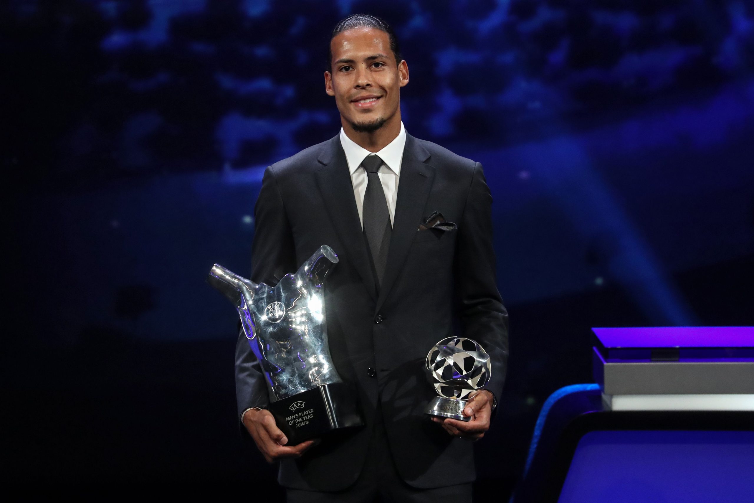 Liverpool's Dutch defender Virgil van Dijk poses with his trophies of Best Men's player in Europe of the Year and Best Defender at the end of the UEFA Champions League football group stage draw ceremony in Monaco on August 29, 2019.