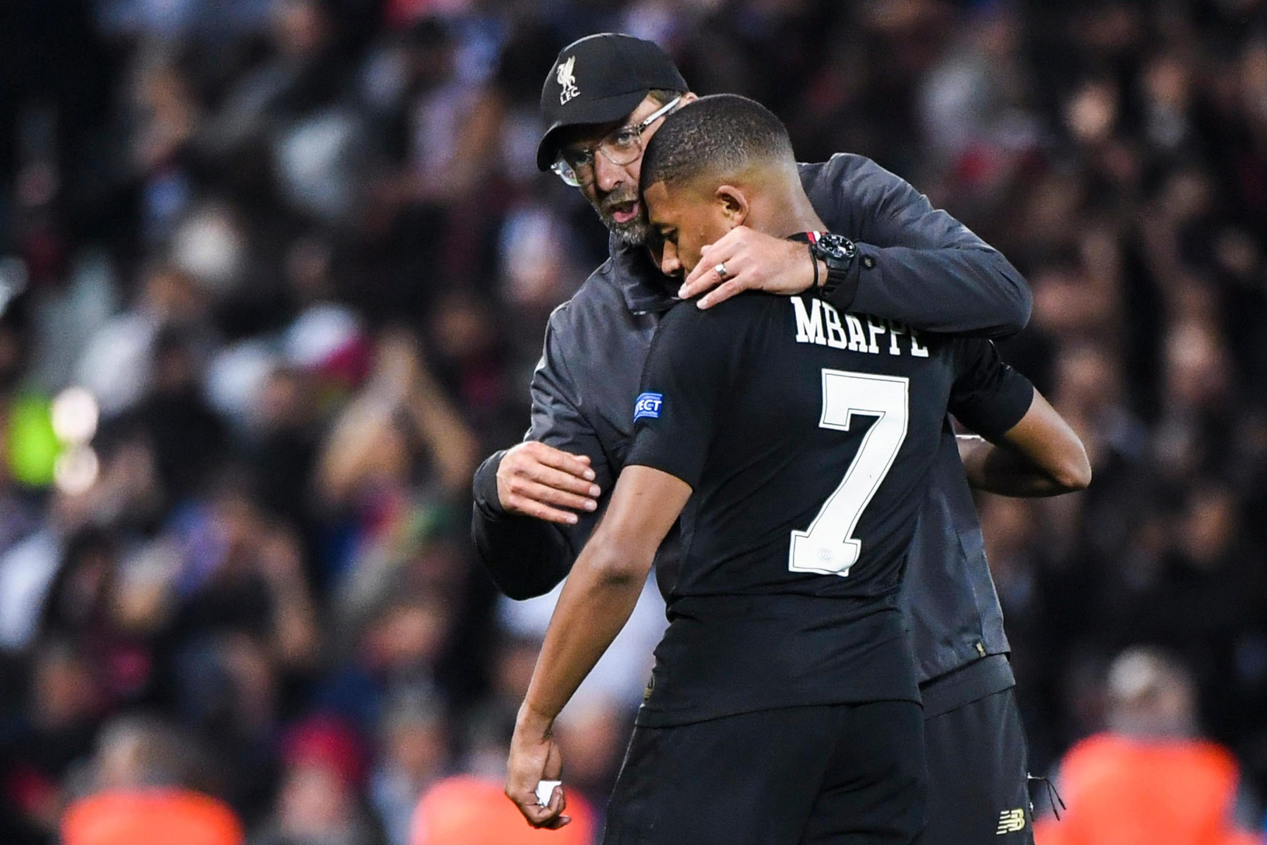Jurgen Klopp coach of Liverpool talks to Kylian Mbappe of PSG during the Champions League match between Liverpool and Paris Saint Germain at Anfield on September 18, 2018 in Liverpool, England.