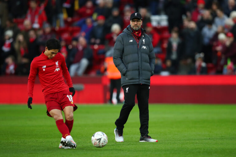 LIVERPOOL, ENGLAND - JANUARY 05: Jurgen Klopp, Manager of Liverpool watches as Takumi Minamino of Liverpool warms up prior to the FA Cup Third Round match between Liverpool and Everton at Anfield on January 05, 2020 in Liverpool, England.