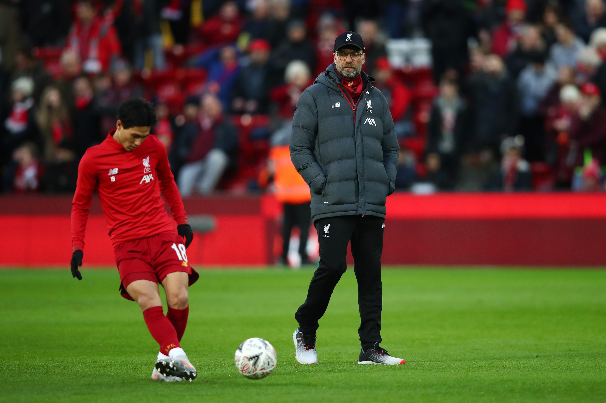 LIVERPOOL, ENGLAND - JANUARY 05: Jurgen Klopp, Manager of Liverpool watches as Takumi Minamino of Liverpool warms up prior to the FA Cup Third Round match between Liverpool and Everton at Anfield on January 05, 2020 in Liverpool, England.