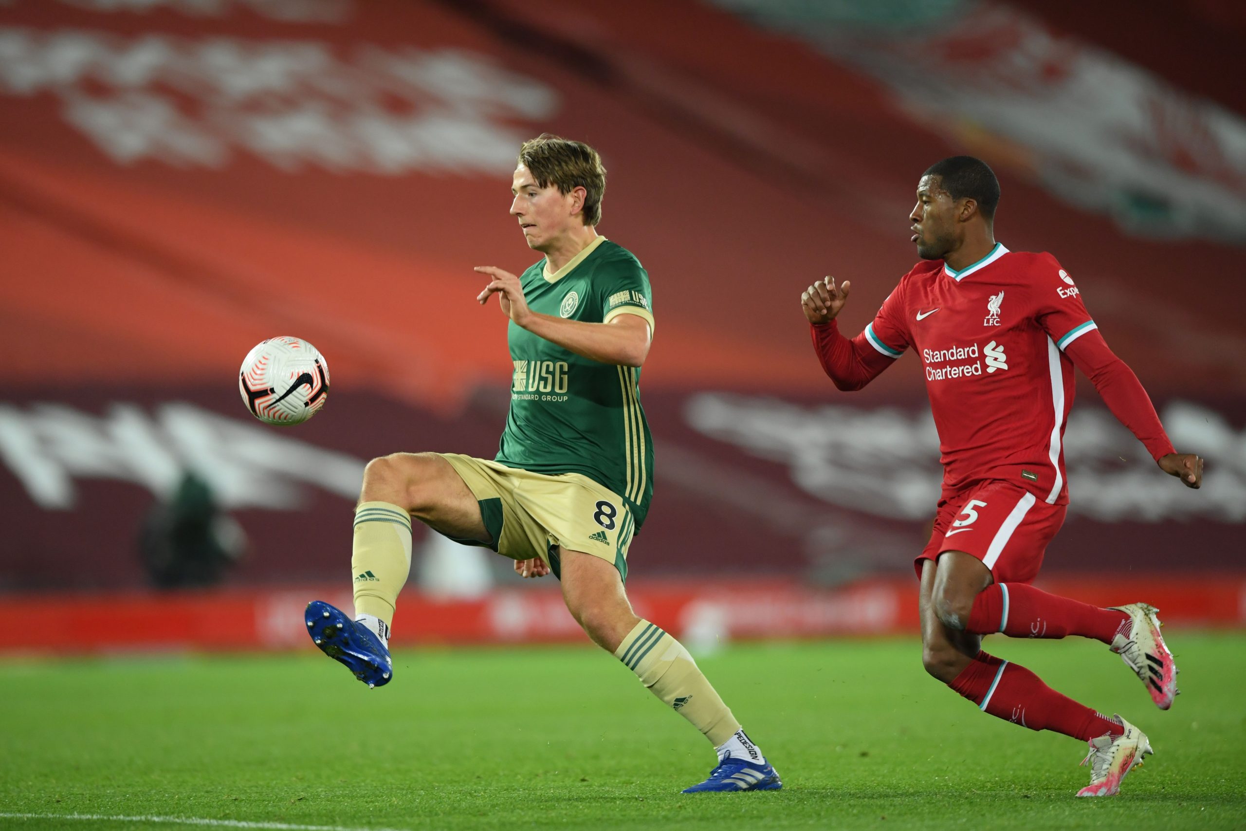 Sheffield United's Norwegian midfielder Sander Berge (L) is pressured by Liverpool's Dutch midfielder Georginio Wijnaldum (R) during the English Premier League football match between Liverpool and Sheffield United at Anfield in Liverpool, north west England on October 24, 2020.