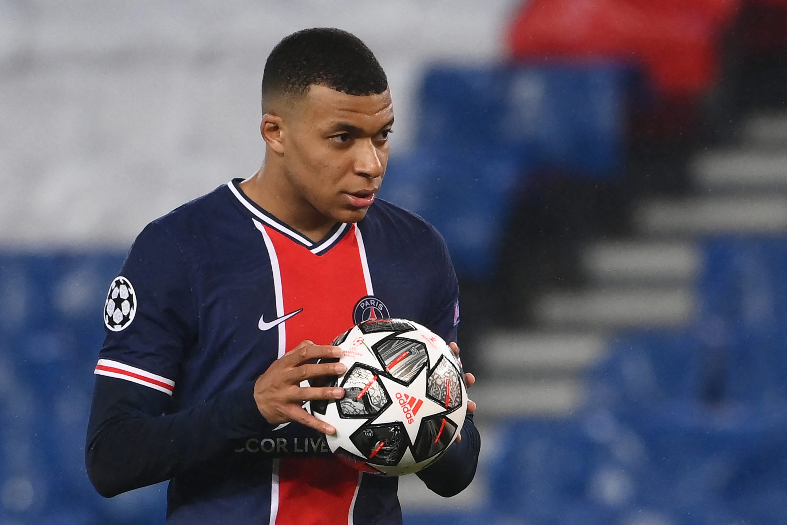 Paris Saint-Germain's French forward Kylian Mbappe holds the ball before kicking a penalty kick during the UEFA Champions League round of 16 second leg football match between Paris Saint-Germain (PSG) and FC Barcelona at the Parc des Princes stadium in Paris, on March 10, 2021.