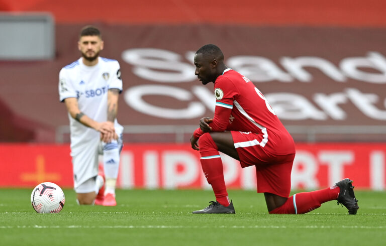 LIVERPOOL, ENGLAND - SEPTEMBER 12: Naby Keita of Liverpool takes a knee in support of the Black Lives Matter movement prior to the Premier League match between Liverpool and Leeds United at Anfield on September 12, 2020 in Liverpool, England.