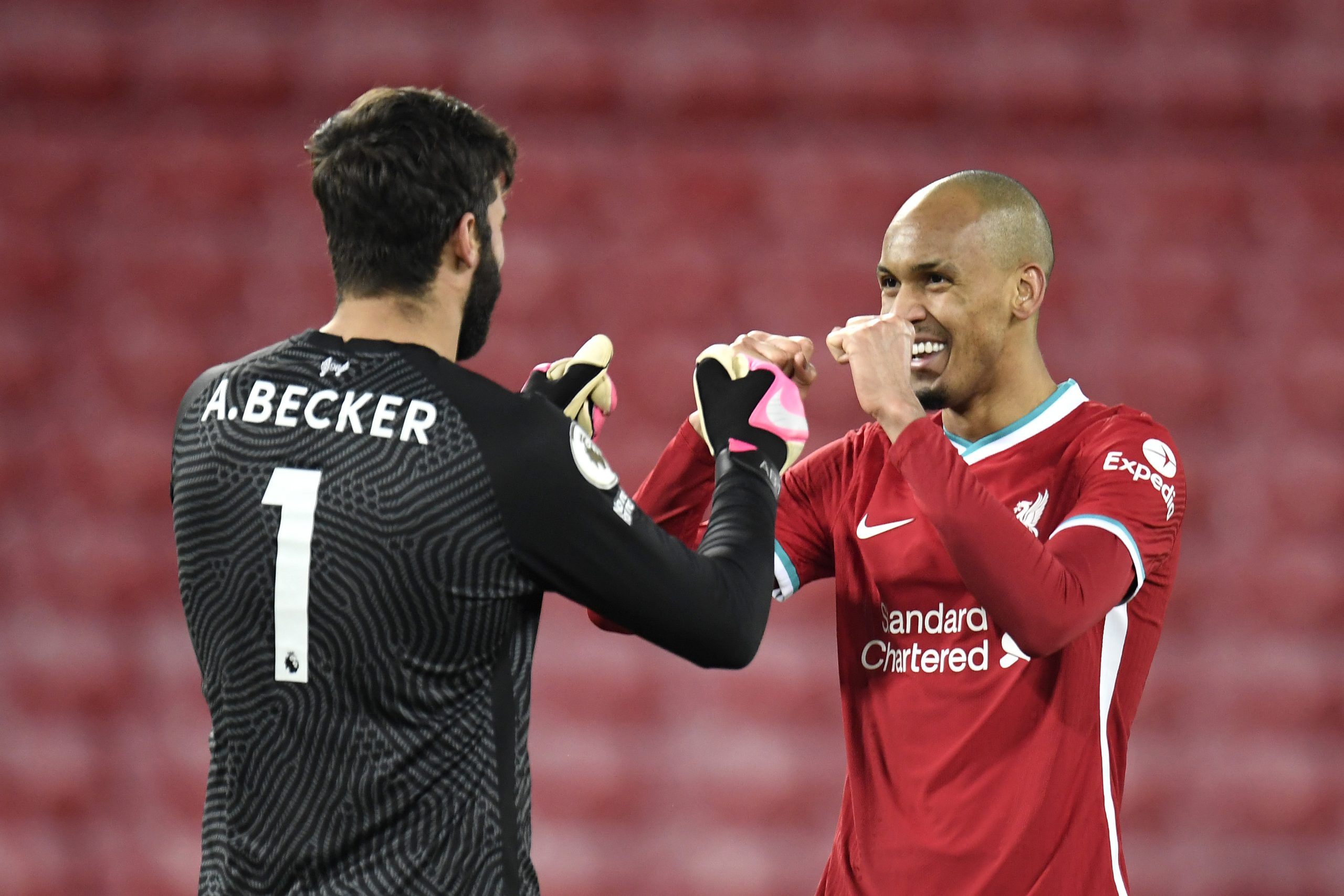 LIVERPOOL, ENGLAND - DECEMBER 16: Alisson Becker of Liverpool celebrates with Fabinho after the Premier League match between Liverpool and Tottenham Hotspur at Anfield on December 16, 2020 in Liverpool, England.