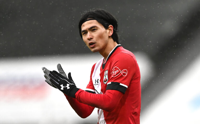 NEWCASTLE UPON TYNE, ENGLAND - FEBRUARY 06: Southampton player Takumi Minamino wearing gloves, gestures during the Premier League match between Newcastle United and Southampton at St. James Park on February 06, 2021 in Newcastle upon Tyne, England.