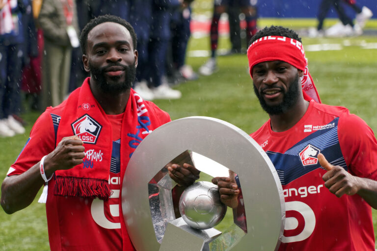 LILLE, FRANCE - MAY 24: Jonathan Ikone and Jonathan Bamba of Lille OSC celebrate their League 1 championship by receiving the Champions Trophy at training center of Luchin near Lille on May 24, 2021 in Lille, France.