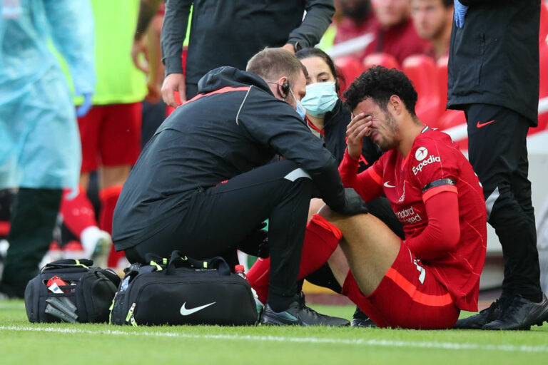 LIVERPOOL, ENGLAND - AUGUST 09: Curtis Jones of Liverpool reacts after picking up an injury which results in him being taken off during the Pre-Season Friendly fixture between Liverpool and Osasuna at Anfield on August 9, 2021 in Liverpool, England. (Photo by Robbie Jay Barratt - AMA/Getty Images)