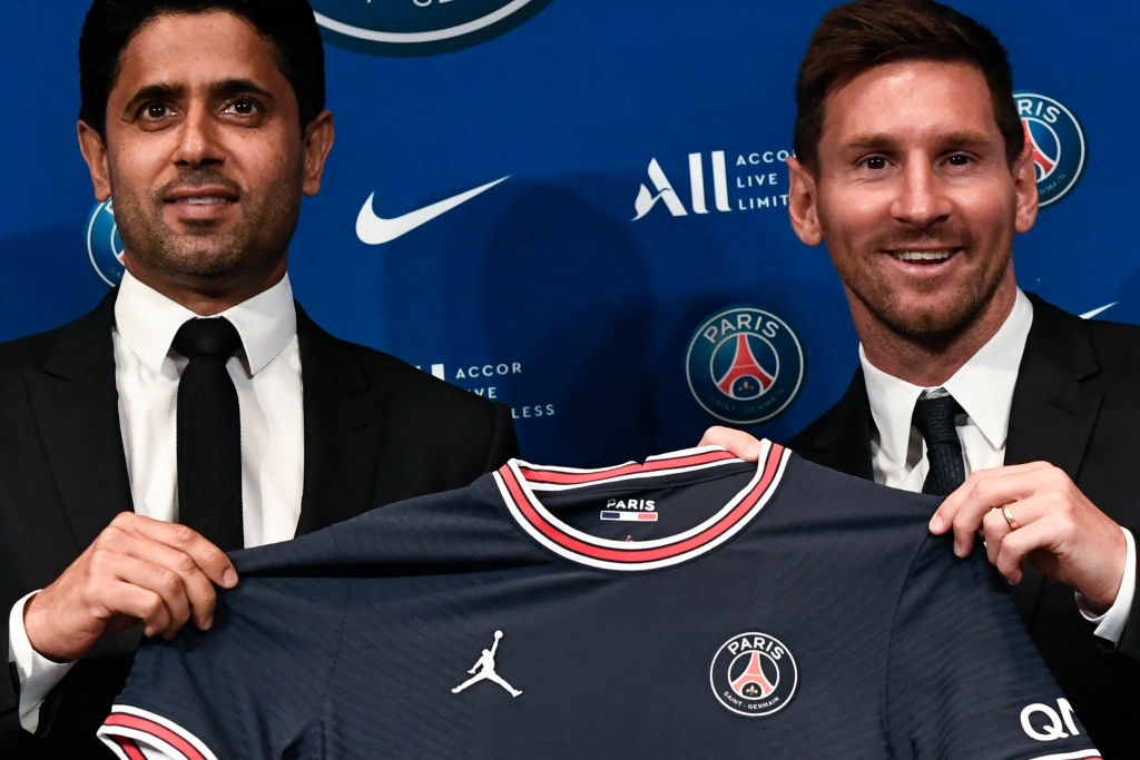 Paris Saint-Germain's Qatari President Nasser Al-Khelaifi (L) poses along side Argentinian football player Lionel Messi as he holds-up his number 30 shirt during a press conference at the French football club Paris Saint-Germain's (PSG) Parc des Princes stadium in Paris on August 11, 2021. - The 34-year-old superstar signed a two-year deal with PSG on August 10, 2021, with the option of an additional year, he will wear the number 30 in Paris, the number he had when he began his professional career at Spain's Barca football club. (Photo by STEPHANE DE SAKUTIN / AFP) (Photo by STEPHANE DE SAKUTIN/AFP via Getty Images)