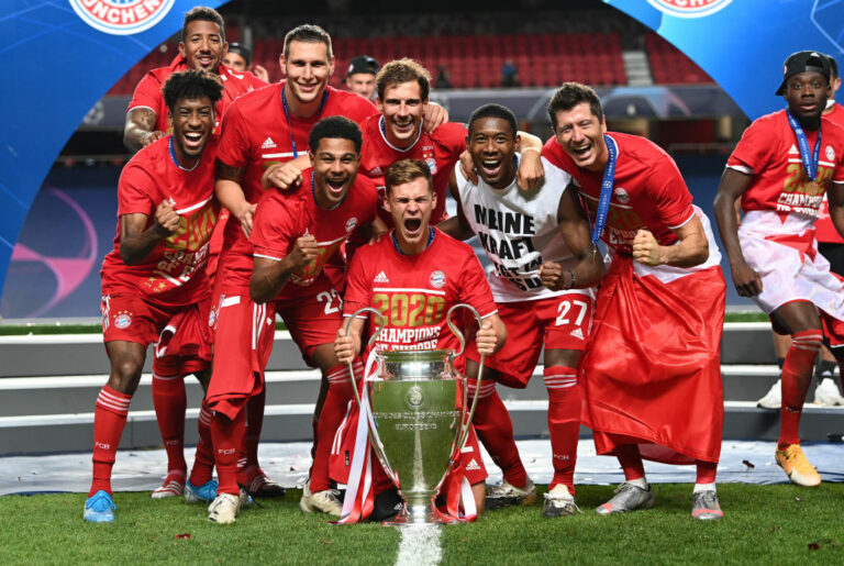 LISBON, PORTUGAL - AUGUST 23: Kingsley Coman, Jerome Boateng, Niklas Suele, Serge Gnabry, Joshua Kimmich, Leon Goretzka, David Alaba, and Robert Lewandowski of FC Bayern Munich celebrate with the UEFA Champions League Trophy following their team's victory in the UEFA Champions League Final match between Paris Saint-Germain and Bayern Munich at Estadio do Sport Lisboa e Benfica on August 23, 2020 in Lisbon, Portugal. (Photo by Michael Regan - UEFA/UEFA via Getty Images)