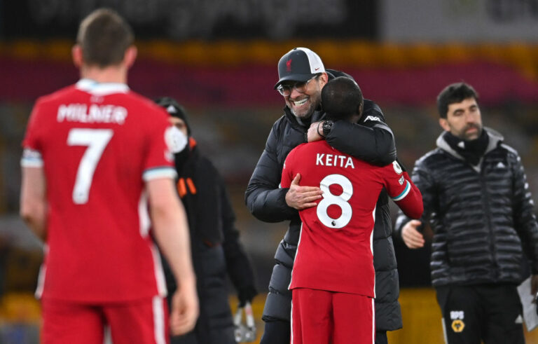WOLVERHAMPTON, ENGLAND - MARCH 15: Jurgen Klopp, Manager of Liverpool celebrates victory with Naby Keita of Liverpool following the Premier League match between Wolverhampton Wanderers and Liverpool at Molineux on March 15, 2021 in Wolverhampton, England. Sporting stadiums around the UK remain under strict restrictions due to the Coronavirus Pandemic as Government social distancing laws prohibit fans inside venues resulting in games being played behind closed doors. (Photo by Laurence Griffiths/Getty Images)
