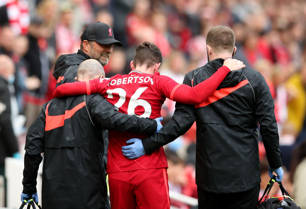 LIVERPOOL, ENGLAND - AUGUST 08: Liverpool manager Jurgen Klopp checks on Andy Robertson of Liverpool as he leaves the pitch with an injury during the pre-season friendly match between Liverpool and Athletic Club at Anfield on August 08, 2021 in Liverpool, England. (Photo by Jan Kruger/Getty Images,)