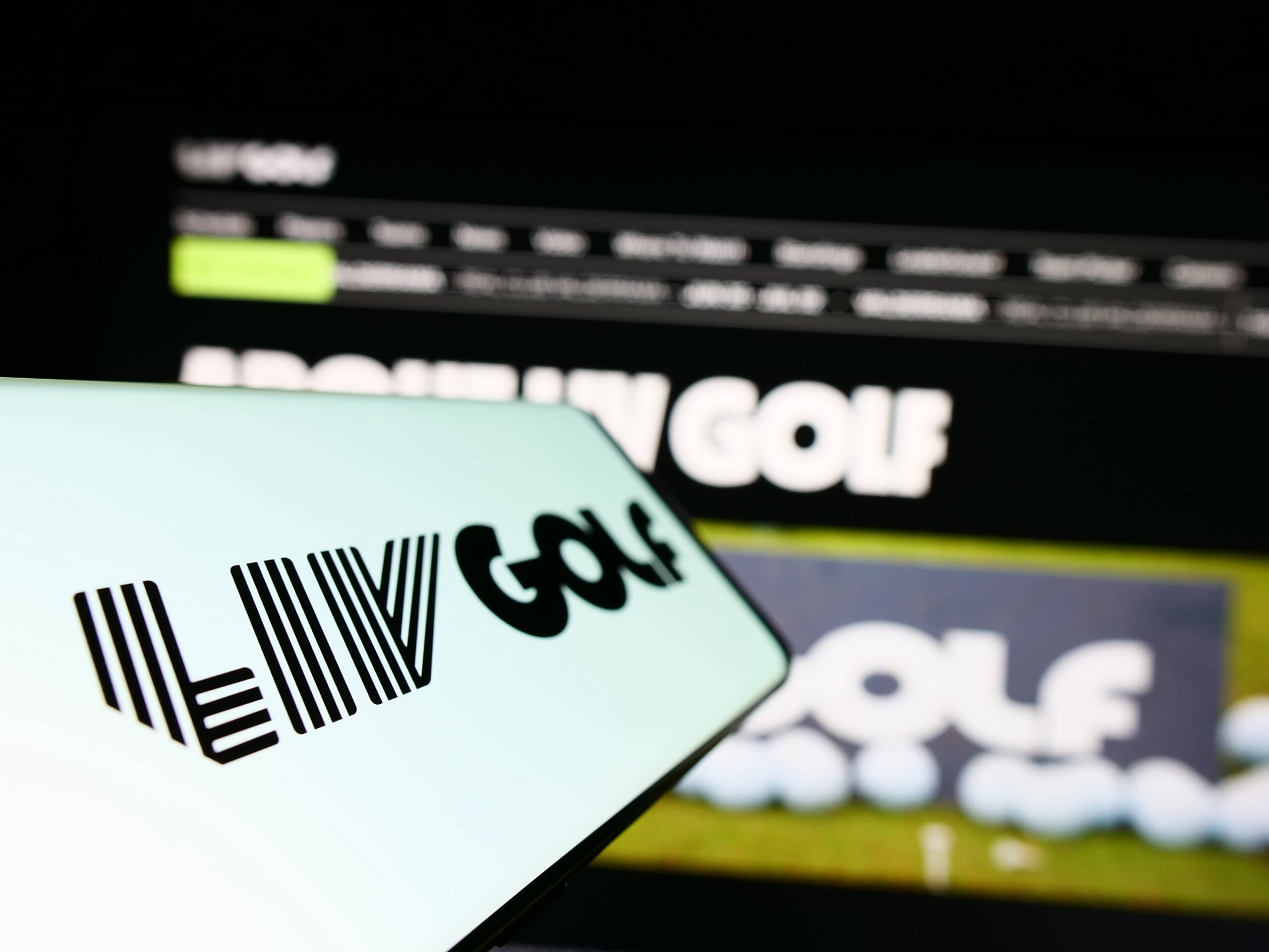 Cellphone with logo of sports organization LIV Golf on screen in front of website. Stuttgart, Germany - 06-17-2023: Cell
